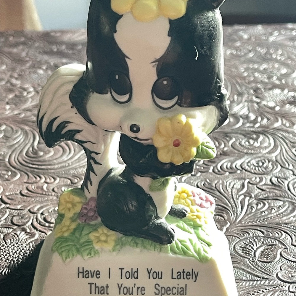 Russ Berrie Skunk Figurine with Yellow Flower.
